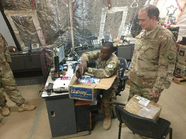 soldier admiring care package items
