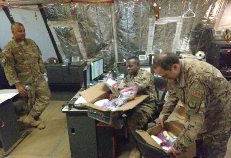 man leaning down opening care package