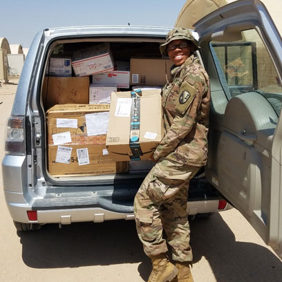 soldier unloading boxes out of van