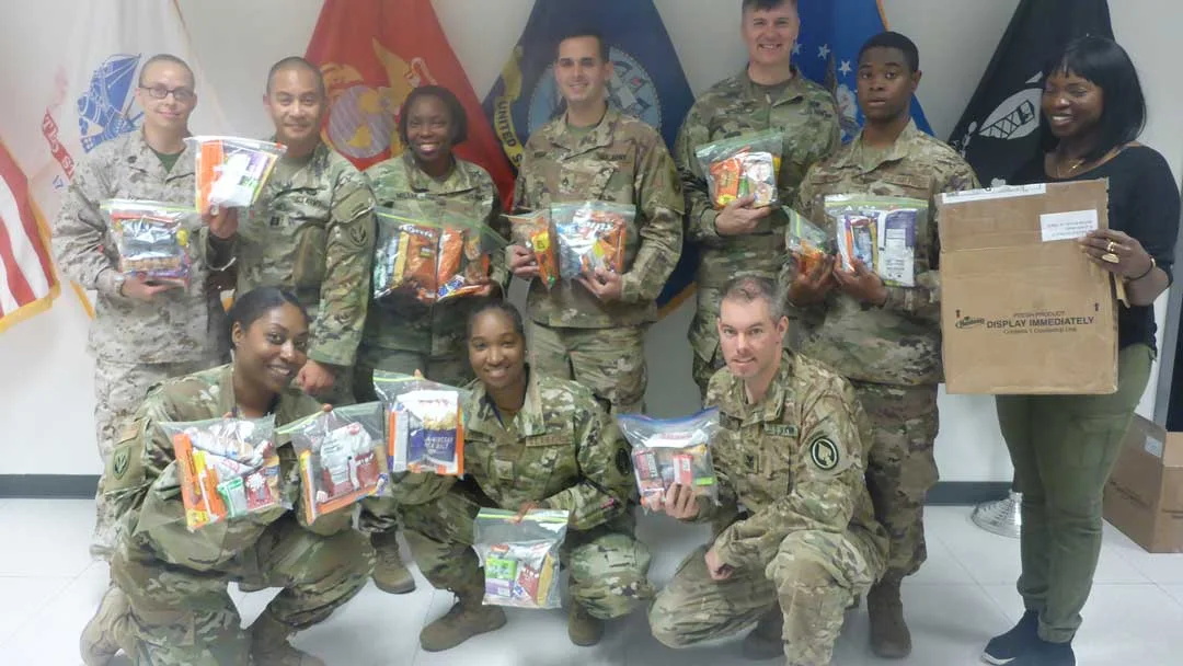 group of soldiers with care packages in qatar