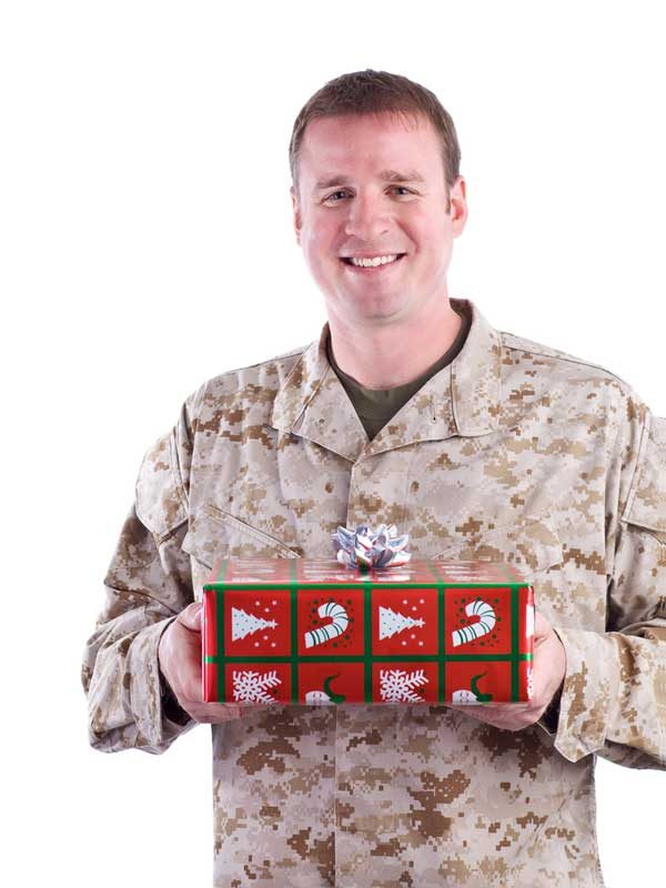 soldier holding a christmas package